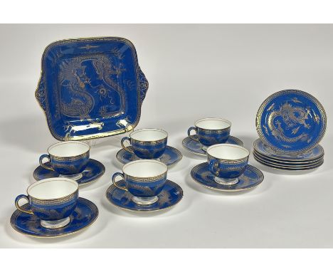 A Wedgwood Blue Dragon Lustre part tea service comprising six tea cups, a serving dish (w-27cm), six plates (w- 15cm) and six