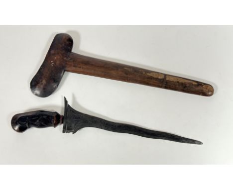 A Kris dagger, probably Japanese, carved wooden handle with stone set mount, wavy steel blade and plain wooden scabbard (47cm