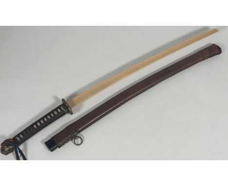 A Japanese army officer's military sword, bound handle with brass fitting and tsuba, later wooden blade and leather covered w