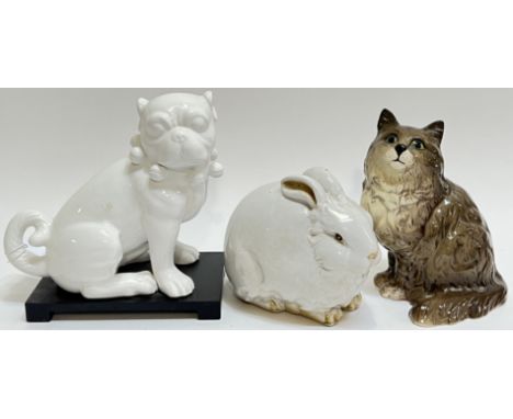 A group of ceramic ornamental animals comprising a Beswick cat (h- 21cm), a white glazed rabbit (h- 14cm, w- 21cm), and a whi