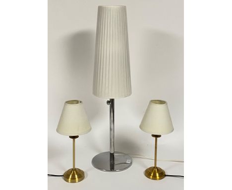 A contemporary chrome plated table lamp with white pleated shade (H86cm) together with a pair of gilt metal table lamps with 