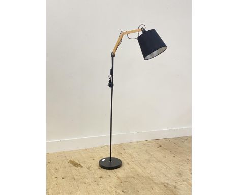 A Contemporary lamp standard, the articulated bulb raised on an aluminium post and circular base. H143cm