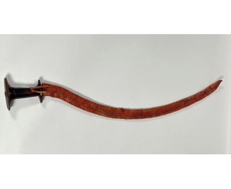An Ethiopian shotel, 20thc., hardwood handle with curved steel blade and leather scabbard (87cm)