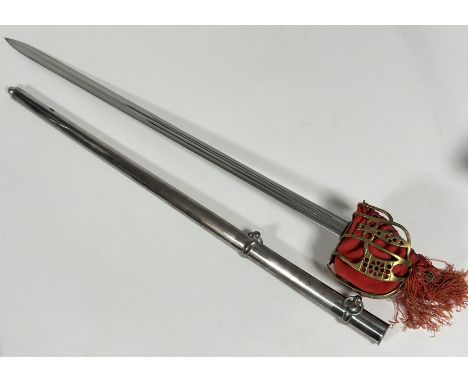 A Scottish brass hilted broadsword, the brass hilt with red felt liner and tassle, steel blade with fullered blade in steel s