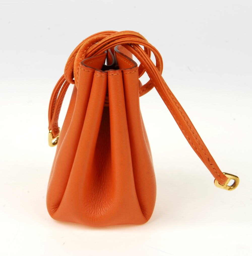 HERMÈS - a orange leather Vespa pouch. Featuring an open top with ...