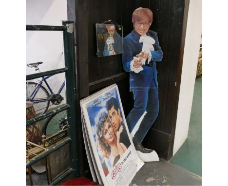 Three framed film prints, Grease, Saturday Night Fever and Dirty Dancing, and cardboard cut-out of Austin Powers