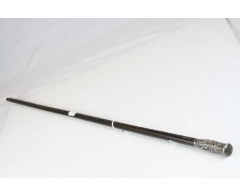 Early 20th century Swagger Stick, the white metal handle with embossed decoration of South East Asian Dragons, 77cms long