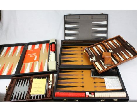 four contemporary  Backgammon sets in travelling cases.