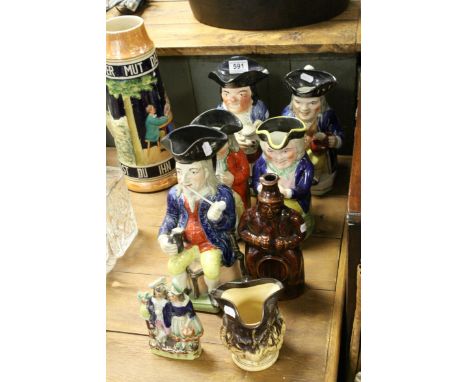 Five 19th century toby jugs to include The Squire smoking pipe,a treacle glazed spirit flask a harvest ware jug and a flatbac