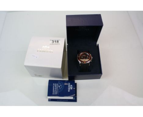 A cased gents Festina quartz chronograph watch with orange and black bezel.