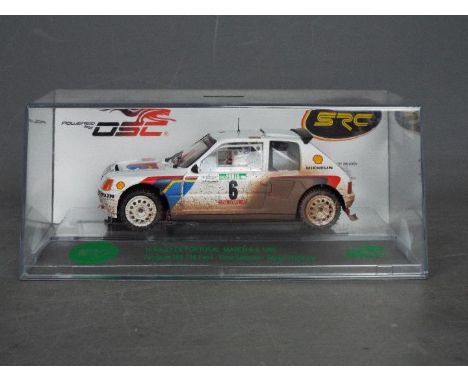 Slot Racing Company - A 1985 Peugeot 205 T16 Evo I rally car in Rally De Portugal livery. # 0124/0515. The car appears in Min