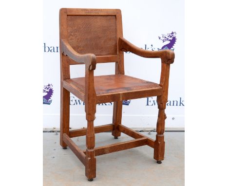 Robert 'Mouseman' Thompson of Kilburn, oak armchair with buttoned brown leather seat, raised on octagonal section legs, one b