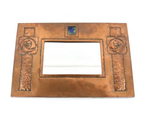 Scottish Arts &amp; Crafts, a copper framed mirror with central enamel plaque and Glasgow rose decoration, 37.5 x 54.5 cm  . 