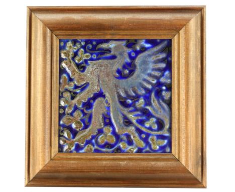 Pilkington's lustre tile designed by J Henry Sellers, depicting a winged creature with forked tail, against a field of three 