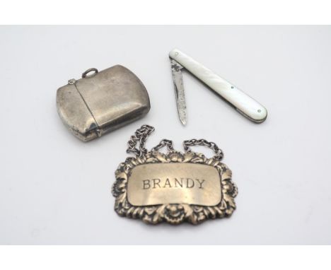 Silver Brandy Label, Silver Match Vesta and a Mother of Pearl Handled Fruit Knife 