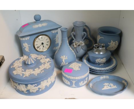 Quantity of blue and white wedgwood jasperware to include clock, pin dishes, table lighter etc 