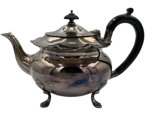 Silver teapot with shaped rim, fluted spout and raised on pad feet, with an ebonised handle and finial, hallmarked Charles Ed