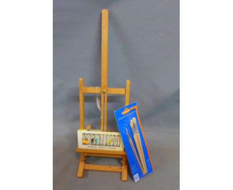 A table top artists easel, with acrylic paints and brushes 