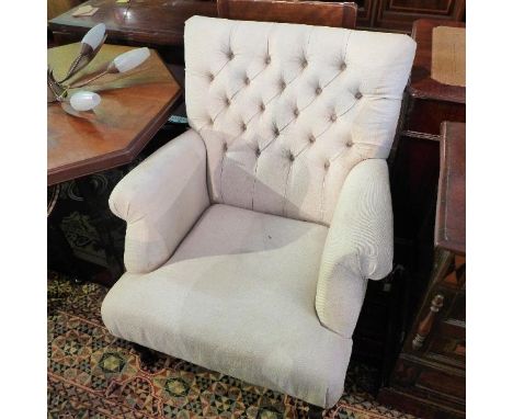 A pair of Victorian style armchairs, with cream button back upholstery, raised on turned legs 