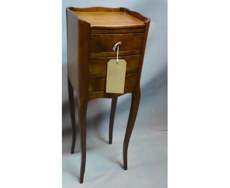 An early 20th century French mahogany lamp table, with three drawers, raised on cabriole legs, H.74 W.24 D.21cm 