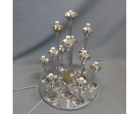 A vintage French chrome centre piece lamp, with 13 torchere lights, lacking glass shades 