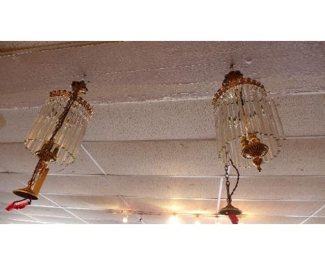 A pair of early 20th century gilt metal chandeliers, with glass stick droplets 