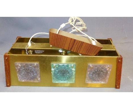 A 1970's brass three spot ceiling light, with teak mounts, having abstract perspex panels 