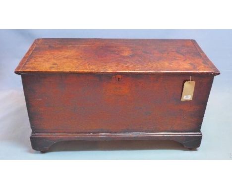 An 18th century oak and elm blanket chest, with hinge lid enclosing candle box, raised on bracket feet, H.55 W.100 D.45cm 