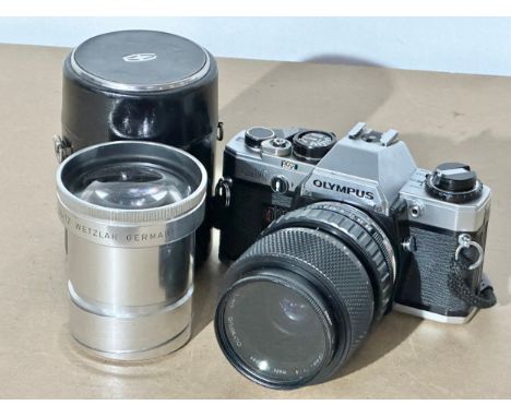 An Olympus OM10 camera, together with Elmaron Leitz Wetzlar lens and case.