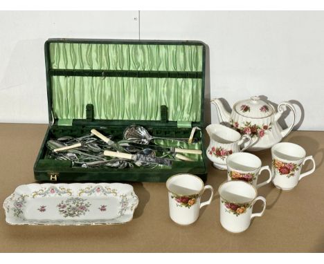 A job lot. 2 Royal Albert “Old Country Roses” coffee mugs. A Paragon “English Rose” teapot and milk jug. A case of cutlery et