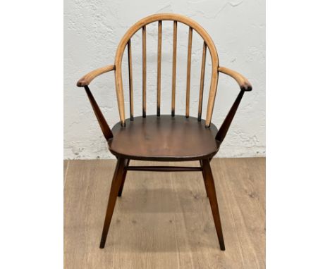 An Ercol Mid Century elm and beech armchair. Model 370a.