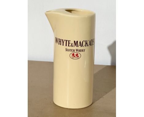 A Whyte &amp; Mackays Scotch Whisky jug. By Wade. 18.5cm