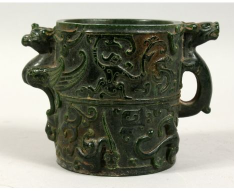 A CHINESE TWO HANDLED CIRCULAR JADE BRUSH POT with figures, birds etc. in relief. 5ins