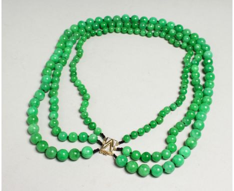 A GOOD SET OF JADE BEADS with gold clasp.