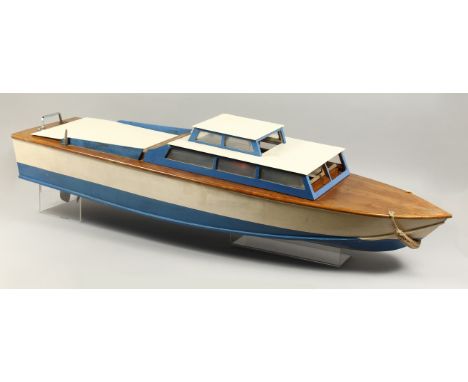 A LARGE MODEL CABIN CRUISER, cream and blue, with engine. 44ins long.
