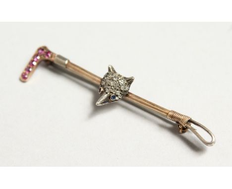 A GOLD AND DIAMOND HUNTING-THEMED BAR BROOCH as a riding crop mounted with a fox's head.
