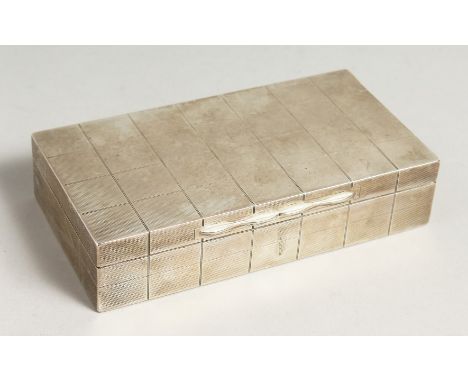 AN ENGINE TURNED RECTANGULAR CIGARETTE BOX with cedarwood linger. 6.5ins long, Birmingham, 1938.