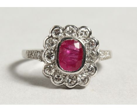 AN 18CT WHITE GOLD RUBY AND DIAMOND CLUSTER RING.