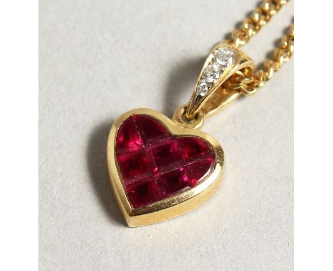 AN 18CT GOLD RUBY SET HEART PENDANT AND CHAIN.