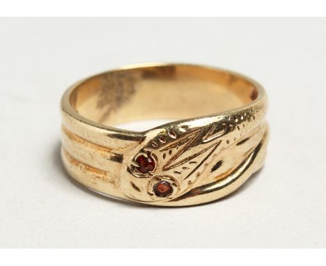 A 9CT GOLD SNAKE RING set with ruby eyes