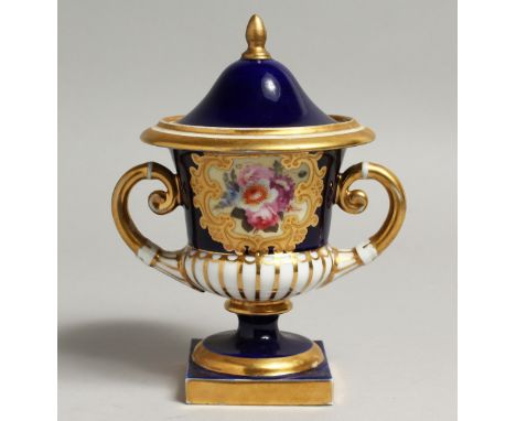 A 19TH CENTURY CHAMBERLAINS WORCESTER VASE AND COVER painted with flowers in raised gilt panel on a cobalt blue ground, scrip