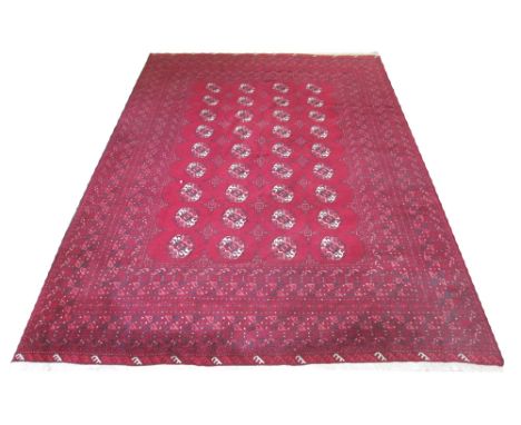 FINE AFGHAN CARPET, 295cm x 207cm, Turkomen repeat gul design on a ruby field within multiple geometric corresponding borders