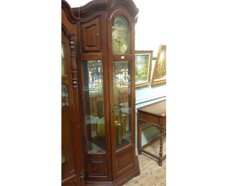 Most decorative modern oak cased clock, the central glazed panel with 3 cylindrical weights and an ornate brass pendulum and 