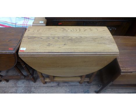 Light oak double drop leaf gate leg table
