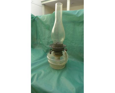 Oil lamp with clear glass base and shaped chimney