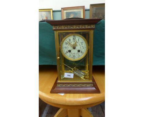 Large ornate brass and wooden cased mantel clock the circular brass surround enamel dial inset coloured garlands with brass p