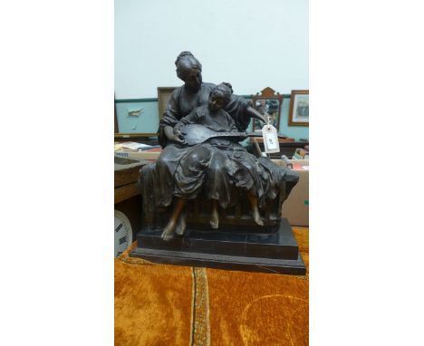 Spelter figure of a child playing a mandolin seated on her mothers lap on a heavy black rectangular marble plinth (approx 20"