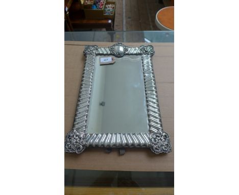 Fine silver framed rectangular toilet mirror with embossed and pierced border with cartouche panel to the upper centre (14 1/