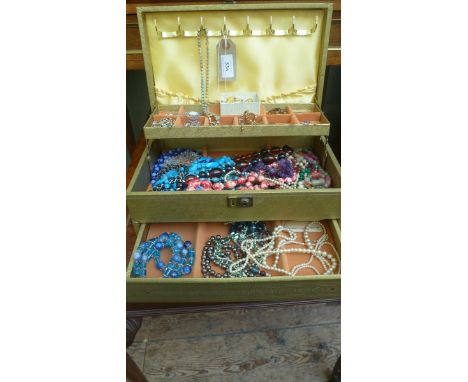 Jewellery  box  containing a selection of coloured beads, pearl necklaces and brooches