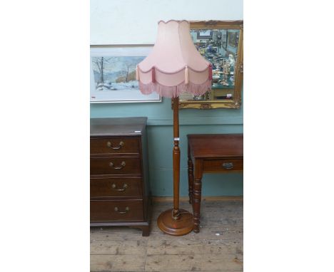 Modern standard lamp on circular base with pink tasselled satin shade